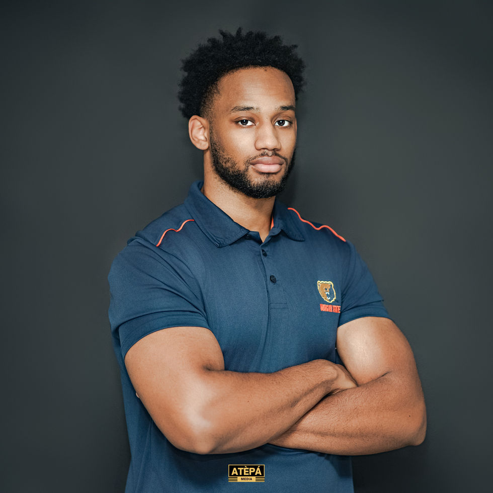 a man stands with his arms crossed wearing a shirt that says atepa