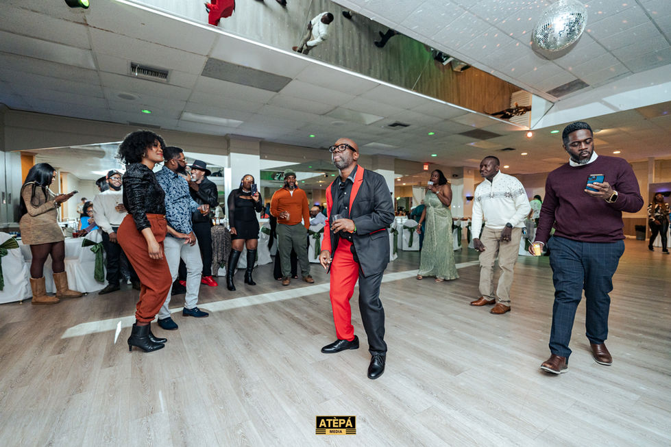 a group of people are dancing in a room with a sign that says atepa