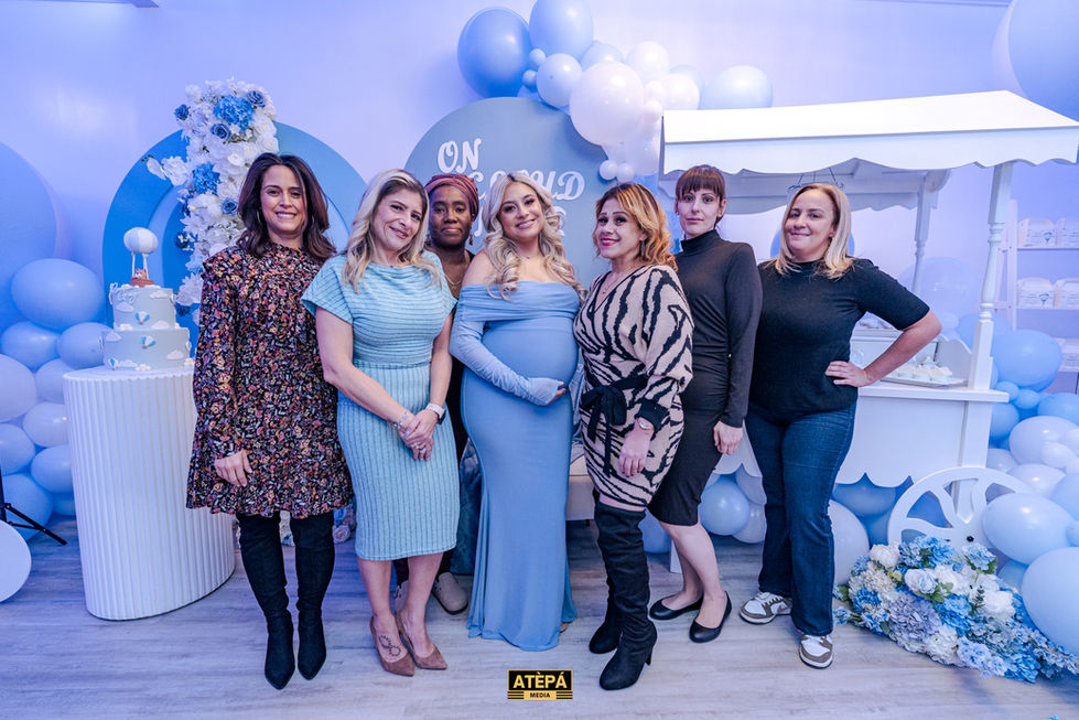 a group of women posing for a picture with a sign that says ' atepa ' on it