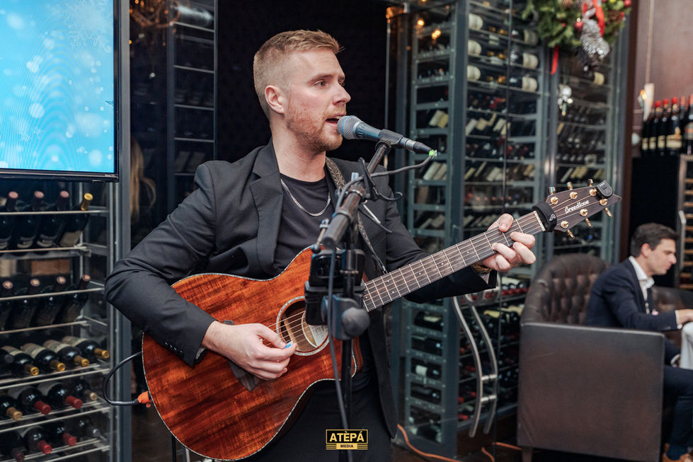 a man singing into a fender guitar