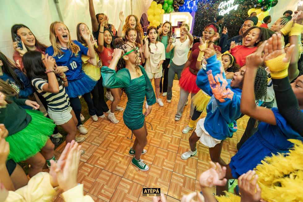 a group of girls are dancing on a dance floor with a sign that says atepa