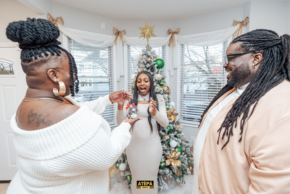 a woman is holding a christmas ornament in front of a christmas tree