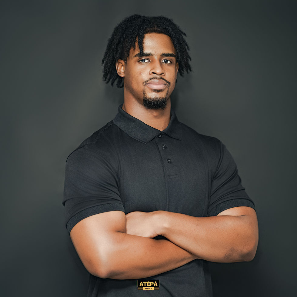 a man wearing a black polo shirt with the word atepa on it