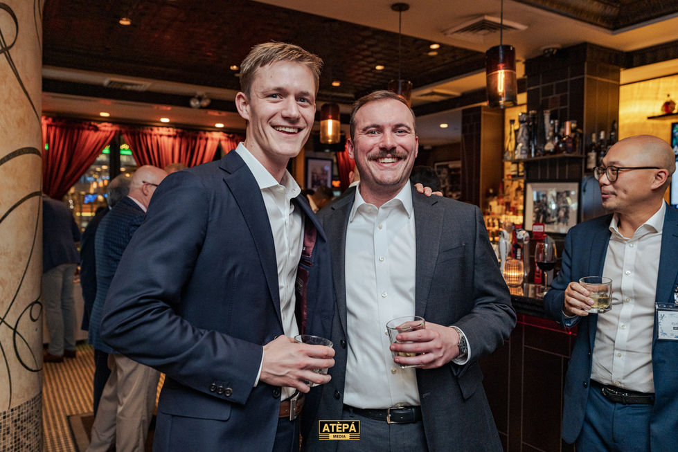 two men standing next to each other with a sign that says atepa on it