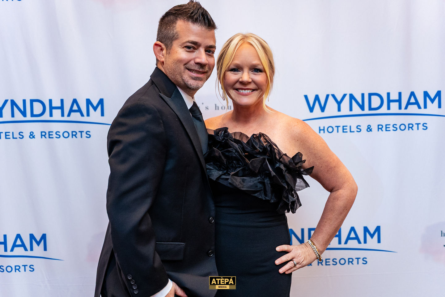 Man and woman posing at Wyndham event.