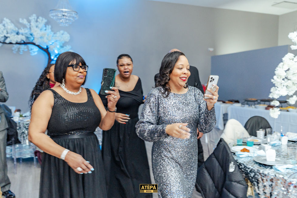 a woman in a silver sequined dress is taking a picture of herself