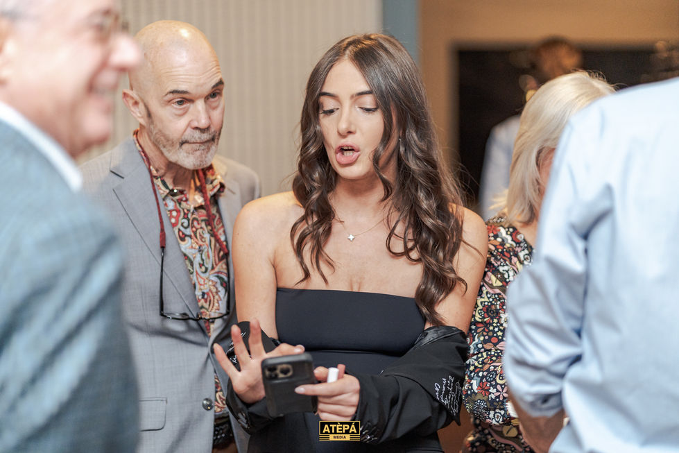 a woman taking a picture with a phone that says atepa on it