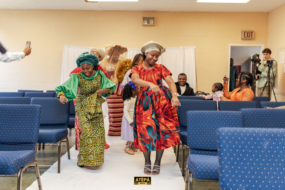 a group of women are dancing in a church with a sign that says atepa on it