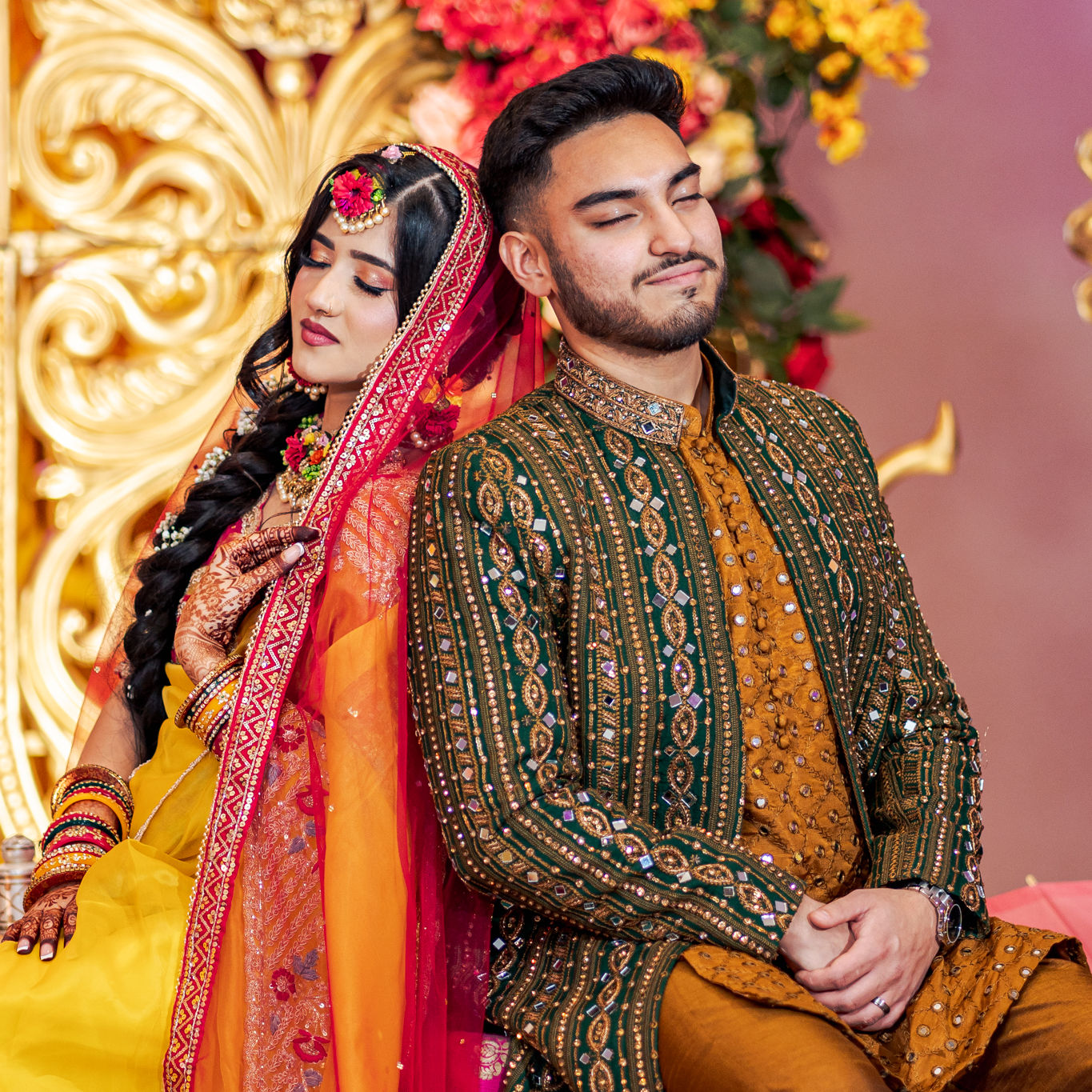 a bride and groom pose for a picture with their eyes closed