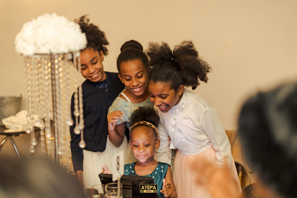 a group of young girls are looking at a device that says atepa on it