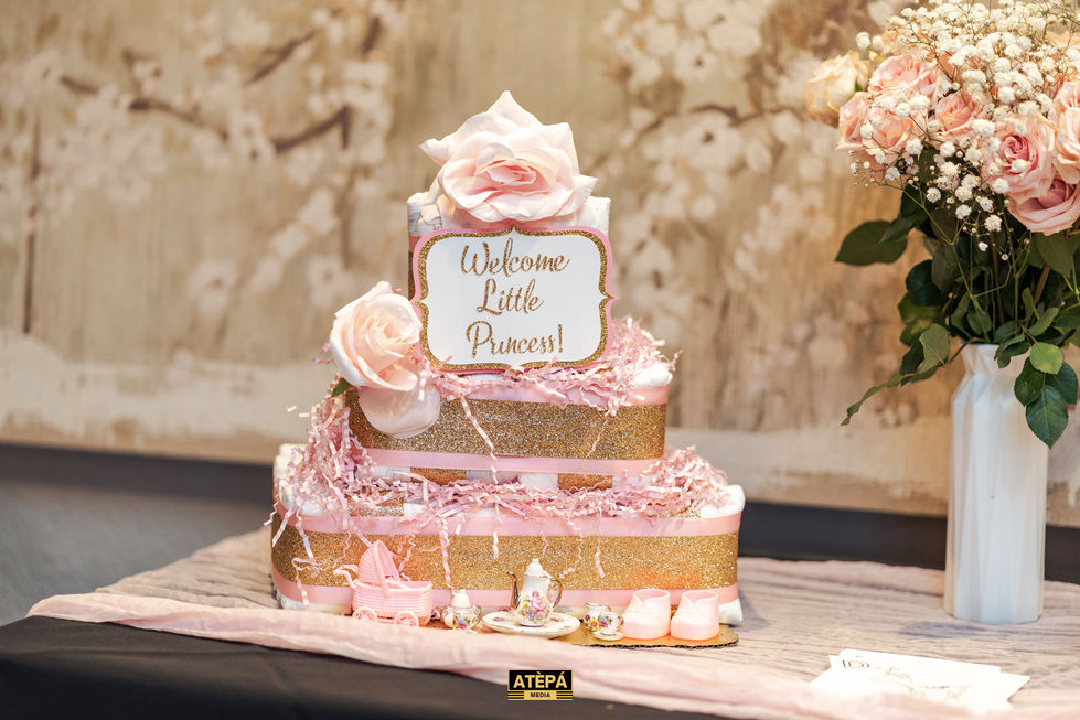 a diaper cake with a sign that says welcome little princess