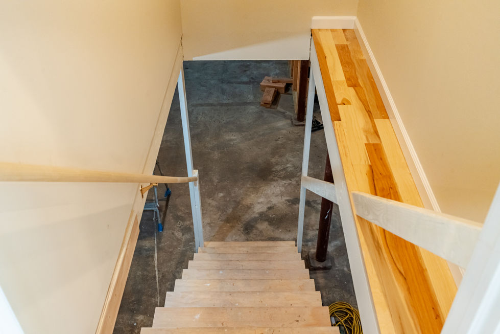 a set of wooden stairs leading up to a concrete floor