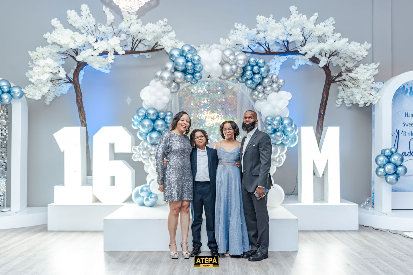 a group of people standing in front of a sign that says 16m