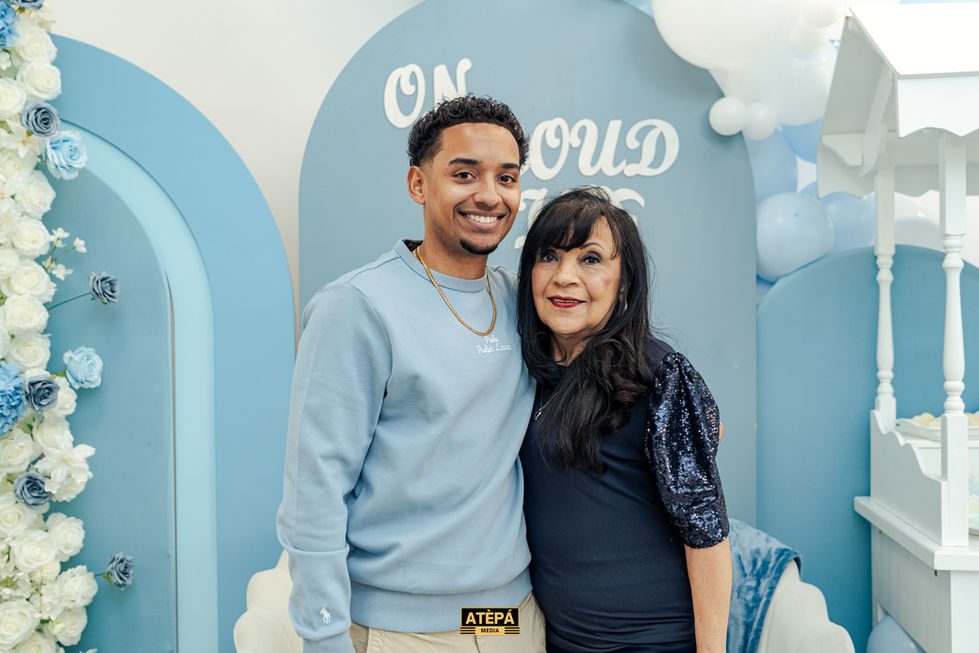 a man and a woman pose for a photo in front of a sign that says on cloud