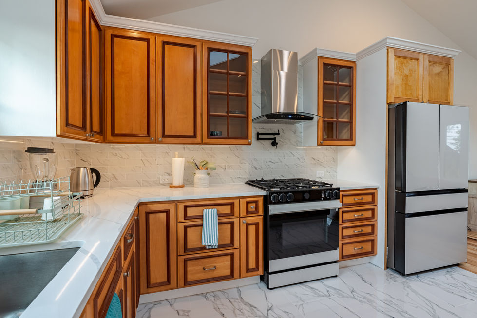 a kitchen with stainless steel appliances and wooden cabinets