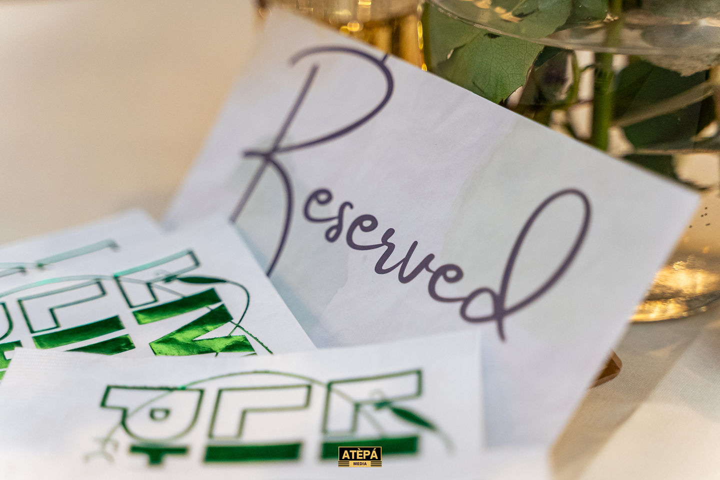 "Reserved" sign on a table with decorative elements.