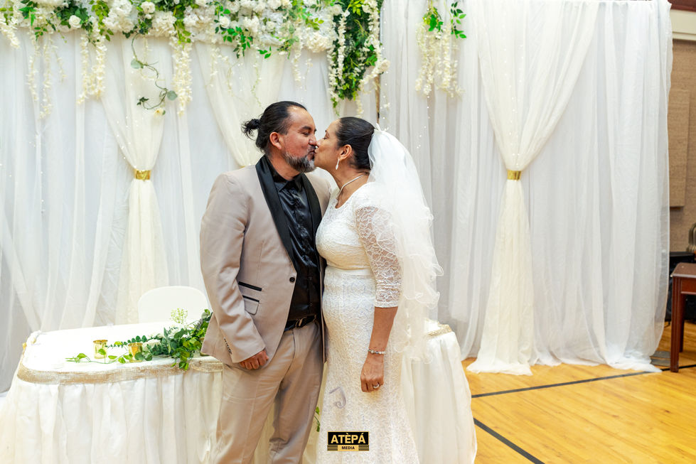 a man and woman kissing with a sign of atepa in the bottom