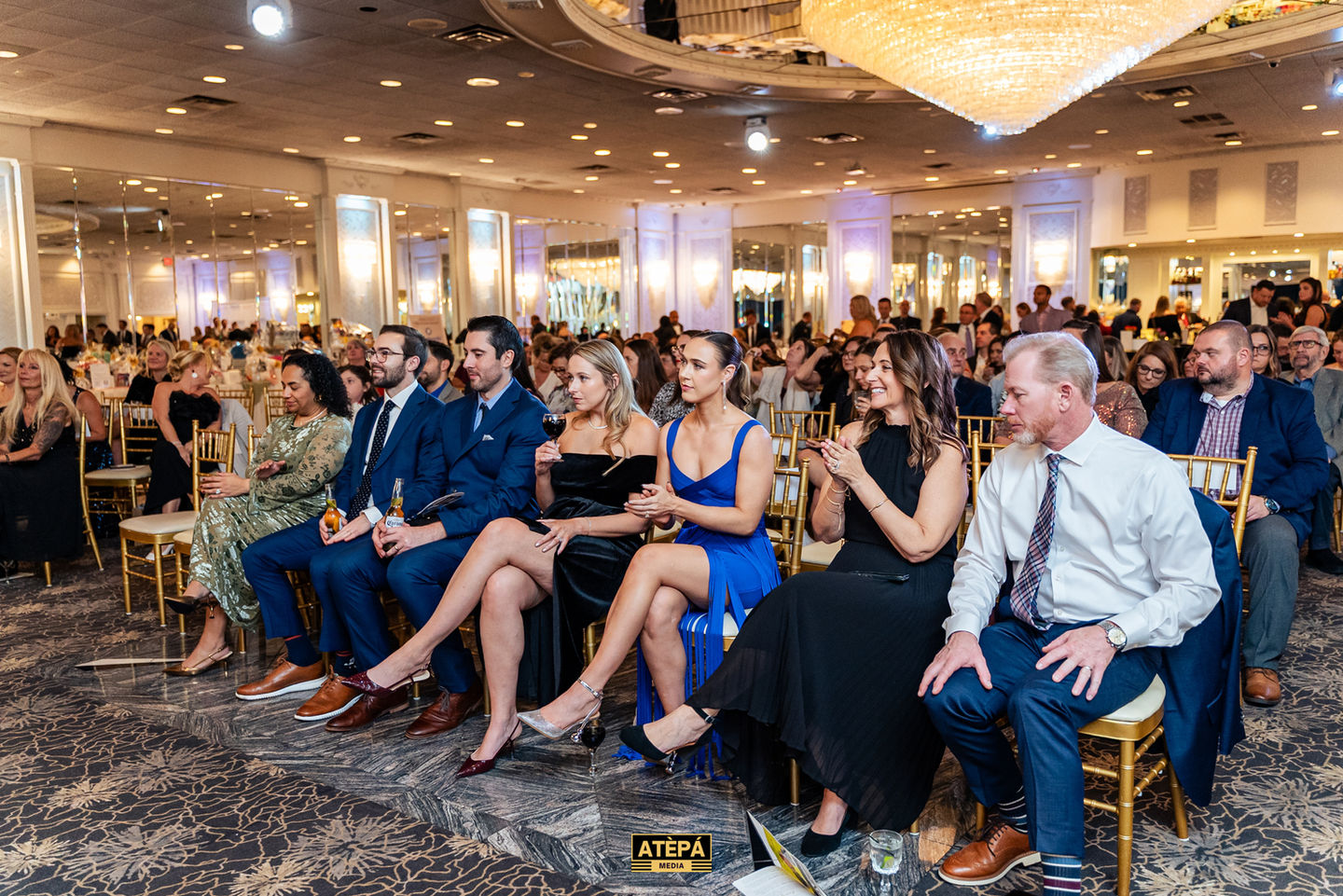 People seated at an elegant event.