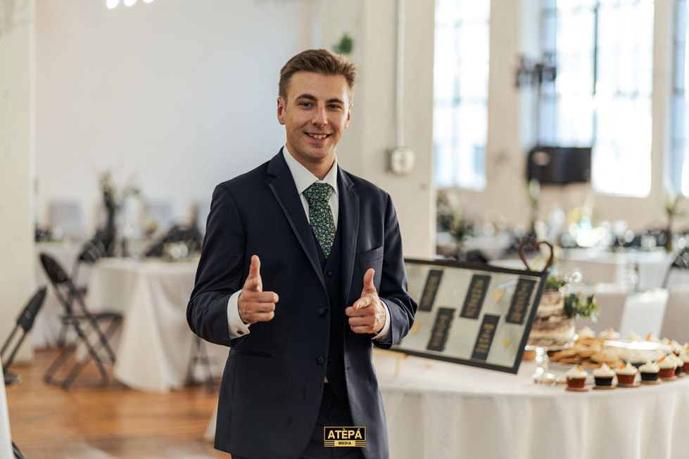 a man in a suit and tie is giving a thumbs up