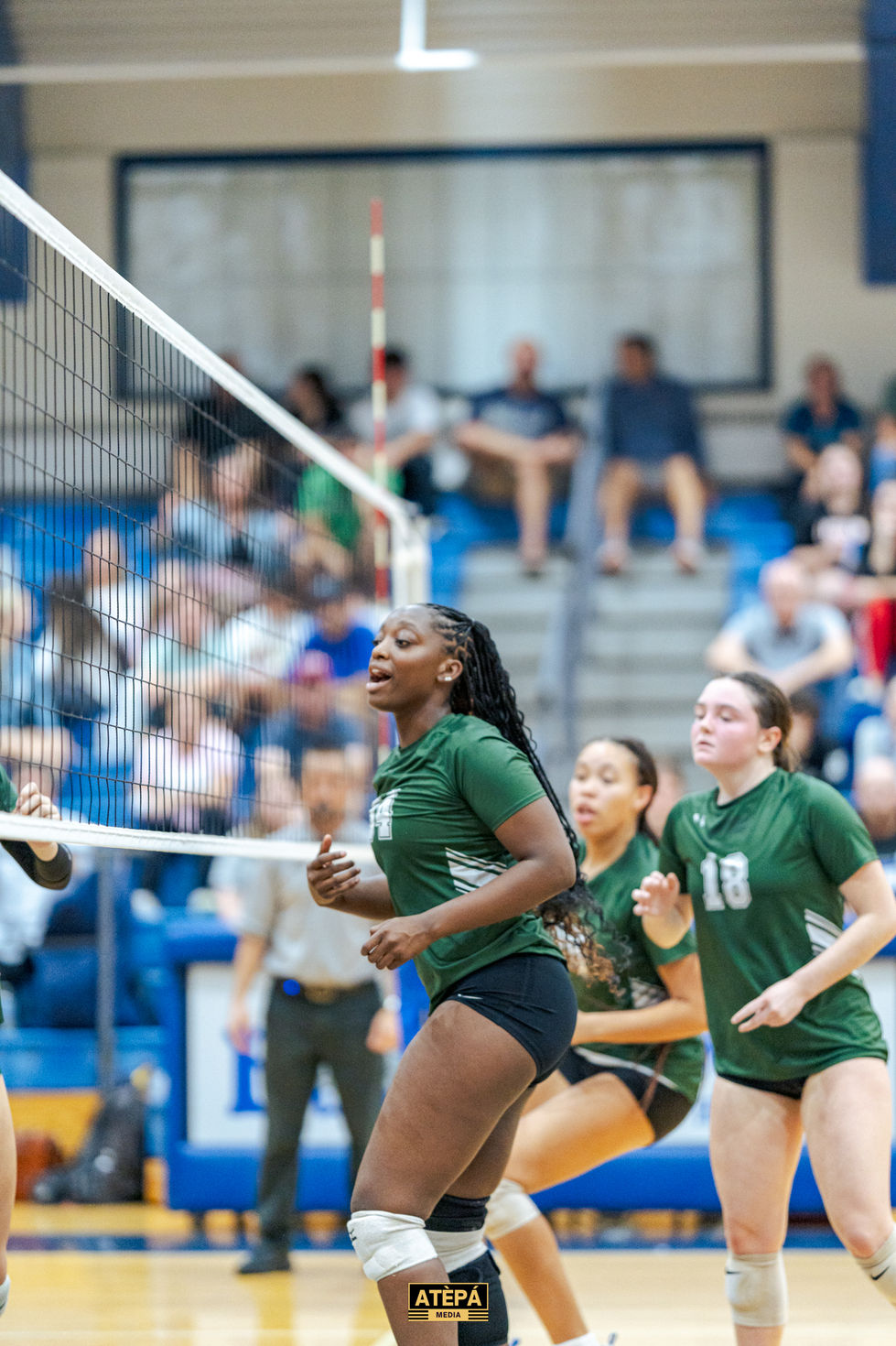 a volleyball player with the number 18 on her shirt