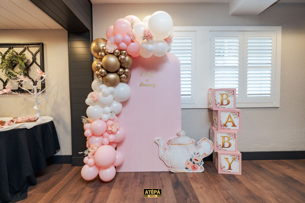 a baby shower decoration with balloons and a teapot