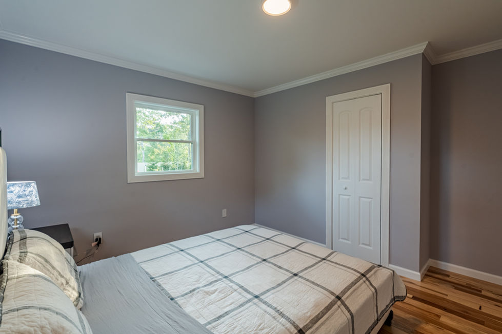 a bedroom with a king size bed and a window