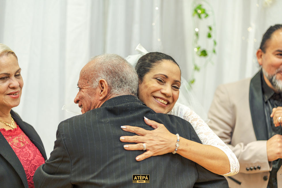 a woman hugging an older man with the word atepa on the back