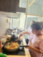 Newly arrived Best Home helpers learn how to cook locally loved dishes.