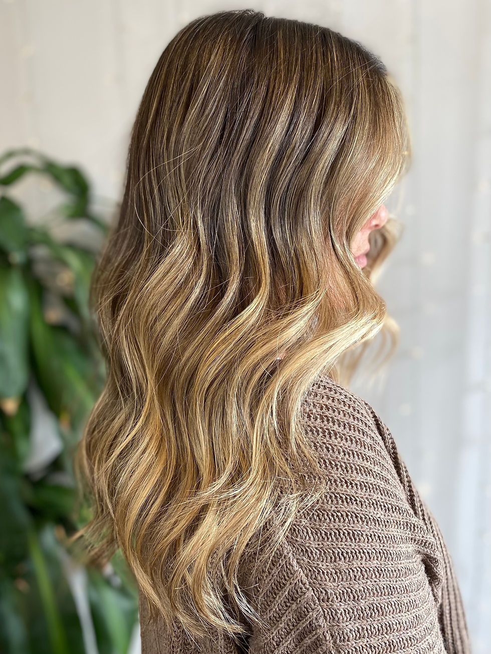 Balayage hair colour with soft blended blonde highlights at an Oshawa hair salon