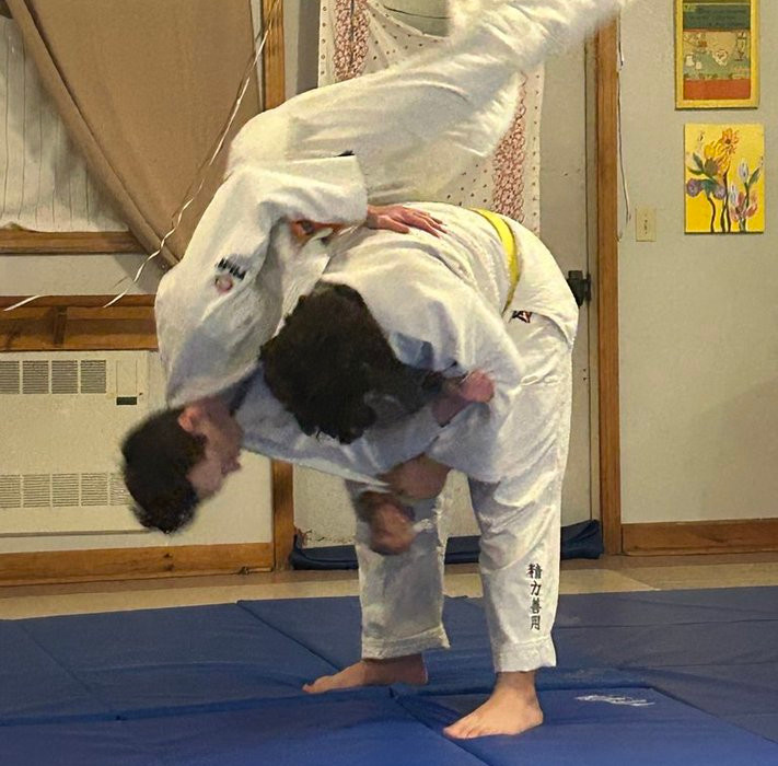 Judoka practicing a shoulder throw
