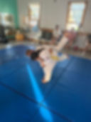 Buzzards Bay Judo students practicing a throw on blue mats.