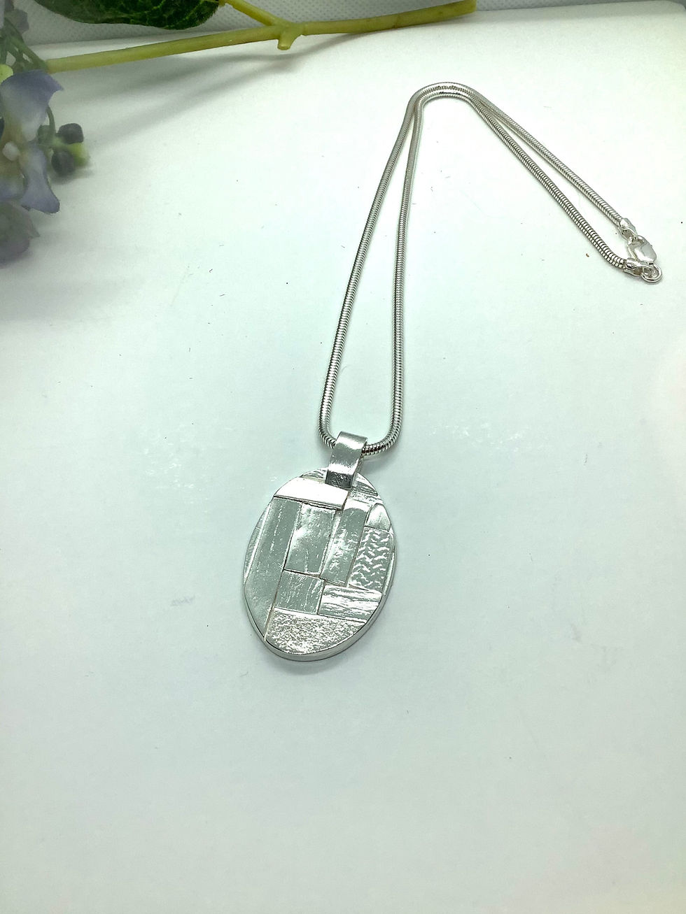 Sterling silver oval puzzle pendant