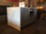 Kitchen island cabinets with granite waterfall top.