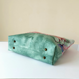 This Bag is the personification of elegance. It combines an attractive printed fabric, be it delicate florals or geometric patterns, with a complementary plain fabric which provides balance and contrasts beautifully. A motif, cut from the printed fabric is hand or machine appliqued to the plain fabric, adding a decorative embellishment. Practicality meets style! Long handles make this bag easy to carry. An internal pocket and secure zip closure keeps treasures safe. What more does it need?