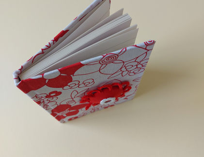 Casebound books covered in fabric are indeed beautiful and have a timeless appeal. The fabric cover and sturdy construction make these books long-lasting and able to withstand frequent handling and the feel adds a tactile dimension to the reading experience, making it more enjoyable. The covering can be made from a variety of textures and colours, giving each book a unique and elegant look. Each book is decorated with either applique or hand embroidery.