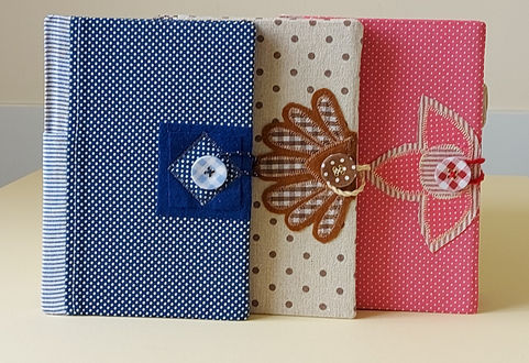Casebound books covered in fabric are indeed beautiful and have a timeless appeal. The fabric cover and sturdy construction make these books long-lasting and able to withstand frequent handling and the feel adds a tactile dimension to the reading experience, making it more enjoyable. The covering can be made from a variety of textures and colours, giving each book a unique and elegant look. Each book is decorated with either applique or hand embroidery.