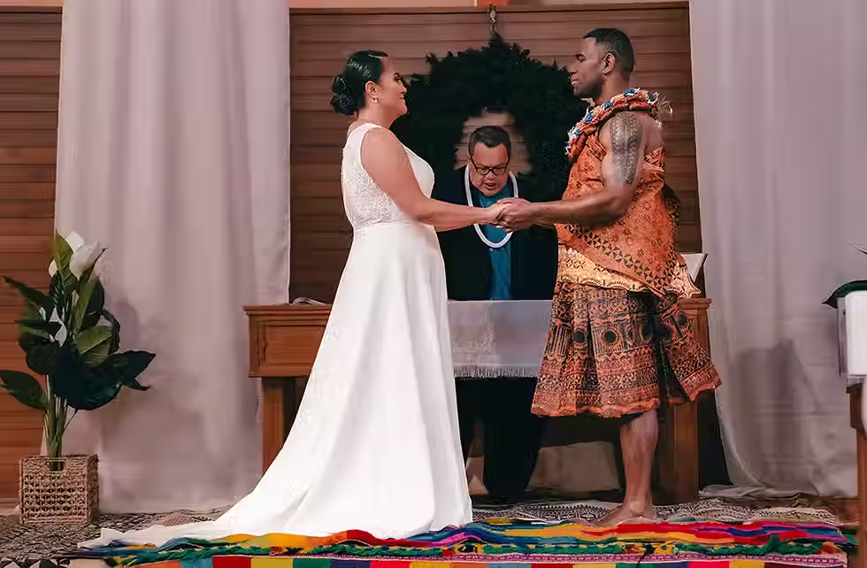 Lincoln wedding photographer capturing Grace and Atunaisa looking lovingly at each other during their ceremony at Lincoln Event Centre, a beautiful Lincoln wedding venue.