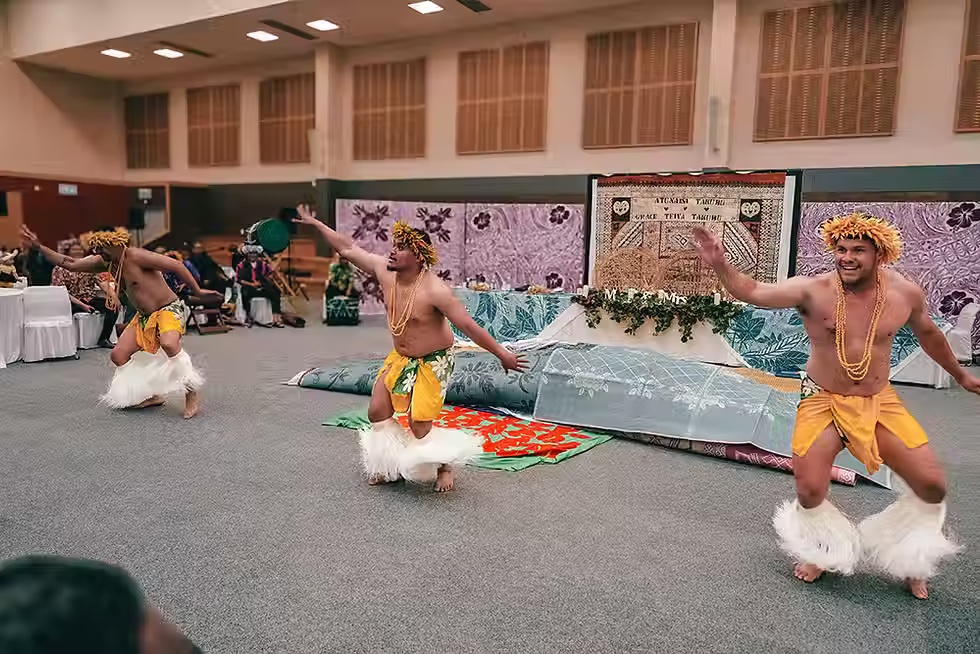 Lincoln wedding photographer: Group of boys in traditional Pacific Island attire performing a dynamic dance at a Lincoln wedding venue.