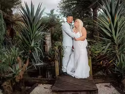 Bride and groom enjoying a romantic moment by the lake at Markovina Estate, captured by affordable wedding photography and videography professionals in Auckland.