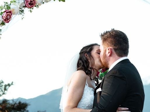 Romantic couple kissing during their wedding in Hanmer Springs, surrounded by natural beauty—captured by Kiwi Moments Media, Christchurch wedding photographer.