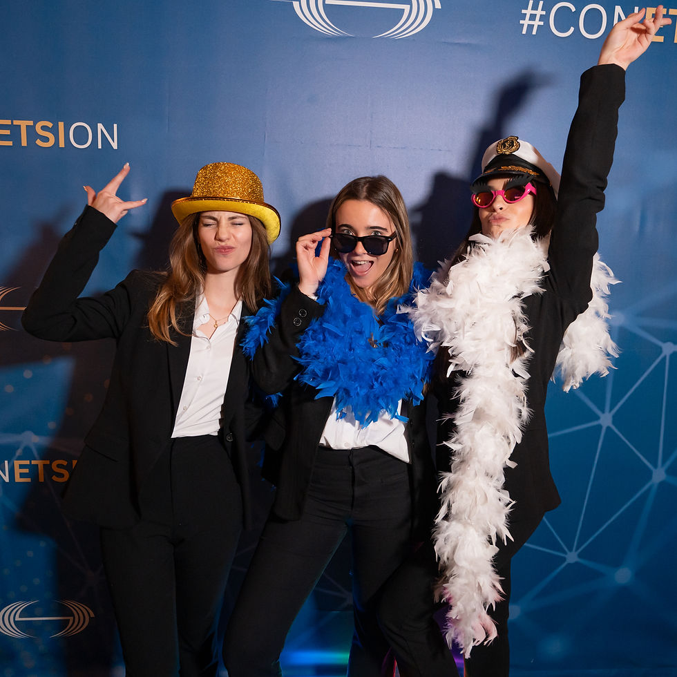 Attendees in costume at the ETSI photobooth, combining playful moments with a formal professional conference setting.