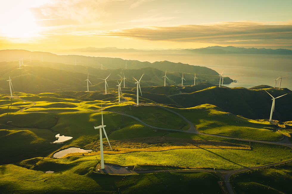 Rolling hills covered with wind turbines at sunset under a golden sky for sustainable energy generation