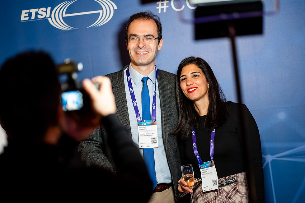 Two attendees posing at the ETSI event photowall, showing professional engagement and human connection.
