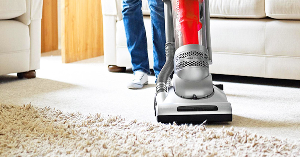 Vacuuming carpet.