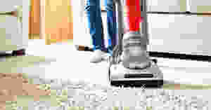 Vacuuming carpet.