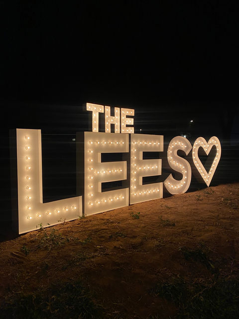 Small "THE" on top of lighted high quality steel powder coated to a white finish spelling "The Lees" with a Heart shaped marquee by Sunshine Glow Co.