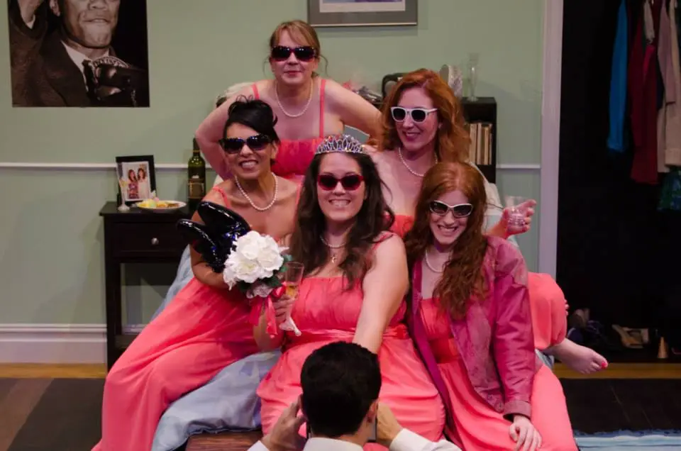 five women wearing the same dress