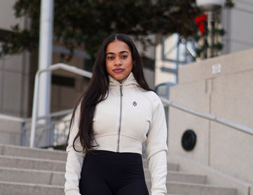 Woman outdoor wearing Aesthetics Dynasty performance hoodie in cream, black jogger outdoor lifestyle