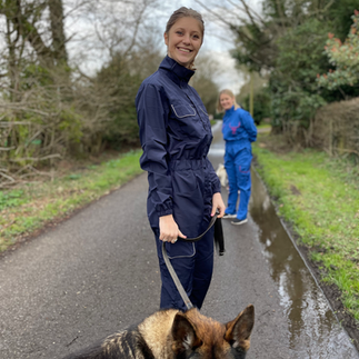 Woman standing with a dog wearing a clipit suit