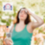 A woman feeling the heat with a bottle of water in her arm